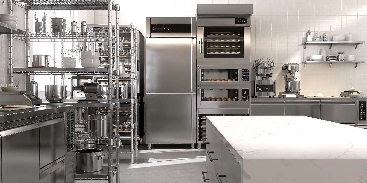 Modern commercial kitchen with stainless steel refrigerators, ovens, and mixers that require regular maintenance to ensure optimal performance